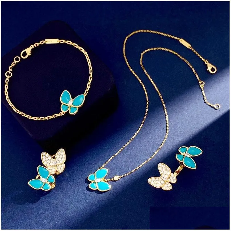 Autres ensembles de bijoux Europe Amérique Mode Dame Femmes Montures en laiton Diamant Turquoise Or Deux boucles d'oreilles papillon Bague_voghion.com