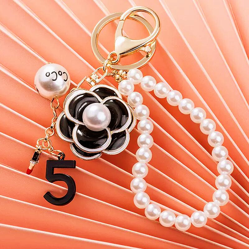 Porte-clés en métal avec pendentif en perle de diamant pour sac à main pour femme, édition coréenne, voiture Camellia de Xiaoxiangfengshan