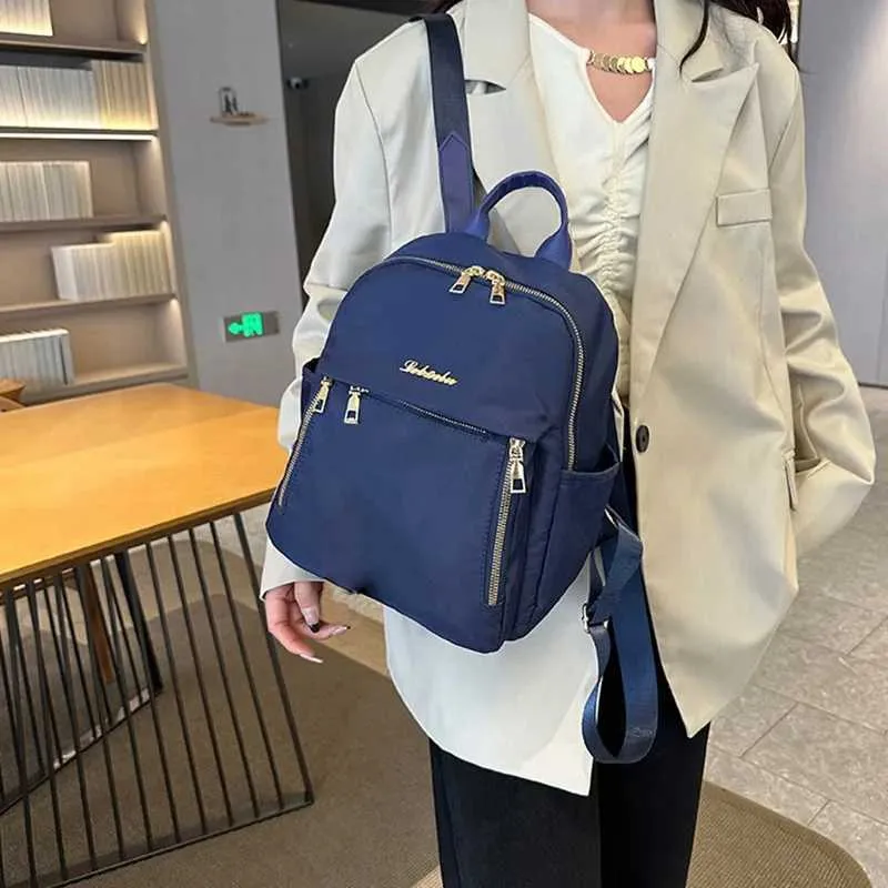 Sac à dos tendance en nylon imperméable à fermeture éclair de grande capacité avec filetage 2024 Hot Selg Sac polyvalent pour femme Mochila Mujer Y241116_voghion.com