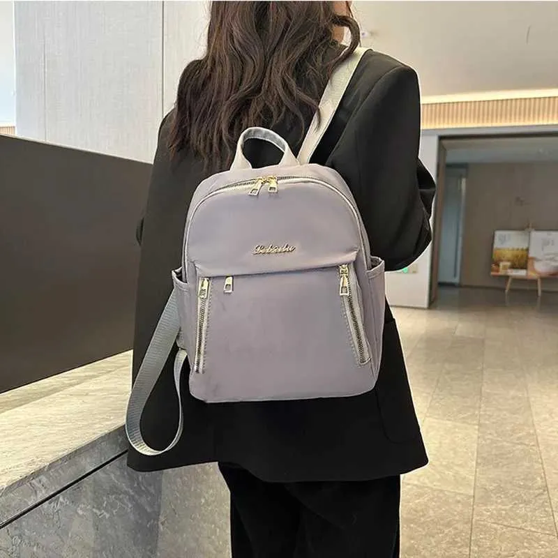 Sac à dos tendance en nylon imperméable à fermeture éclair de grande capacité avec filetage 2024 Hot Selg Sac polyvalent pour femme Mochila Mujer Y241116_voghion.com